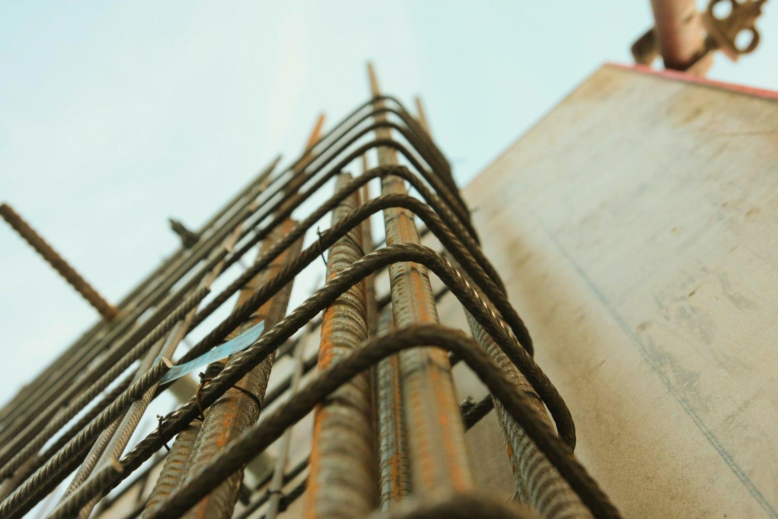Steel reinforcement bars tied at a column head against the sky