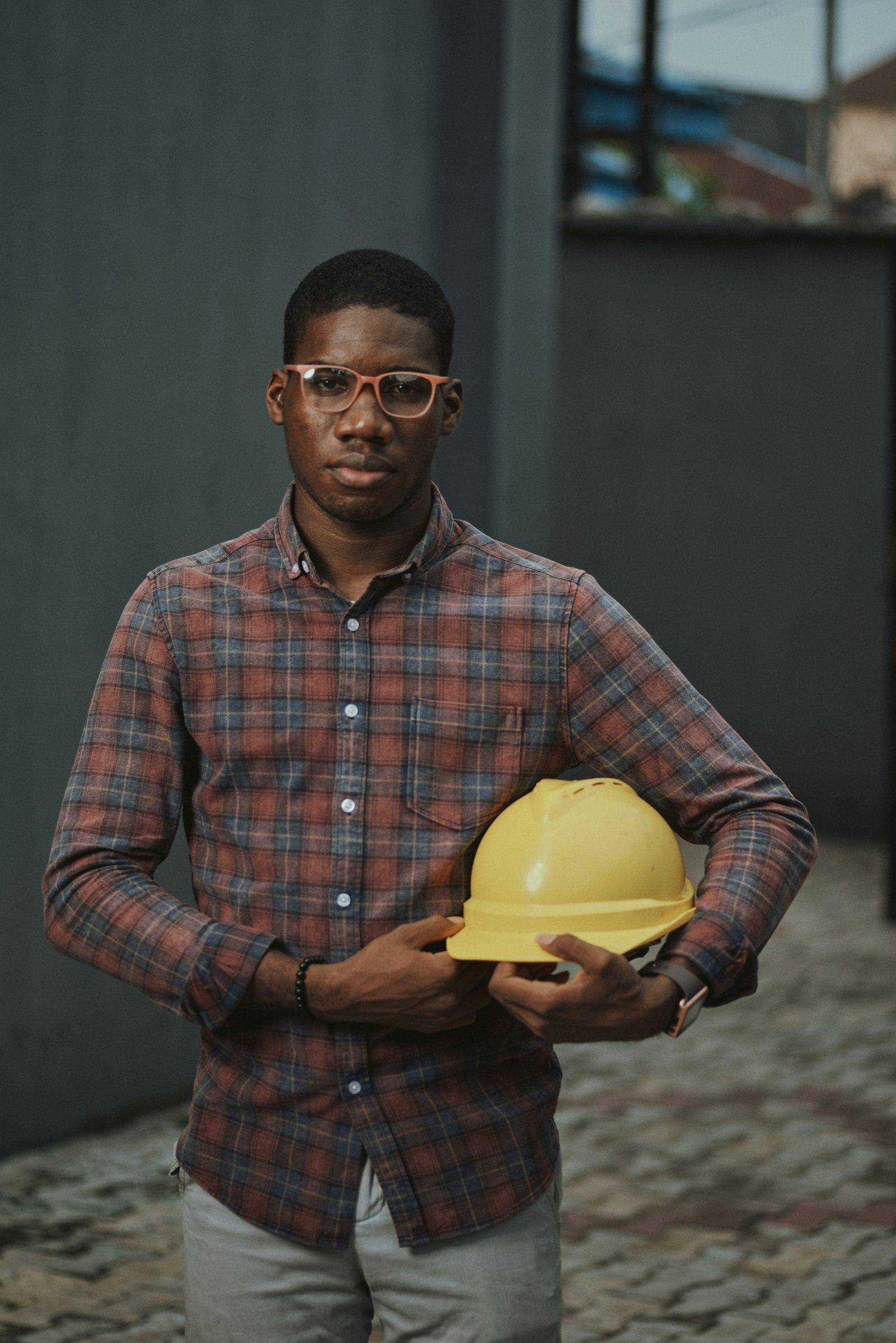 Engineer holding a safety helmet on a project site
