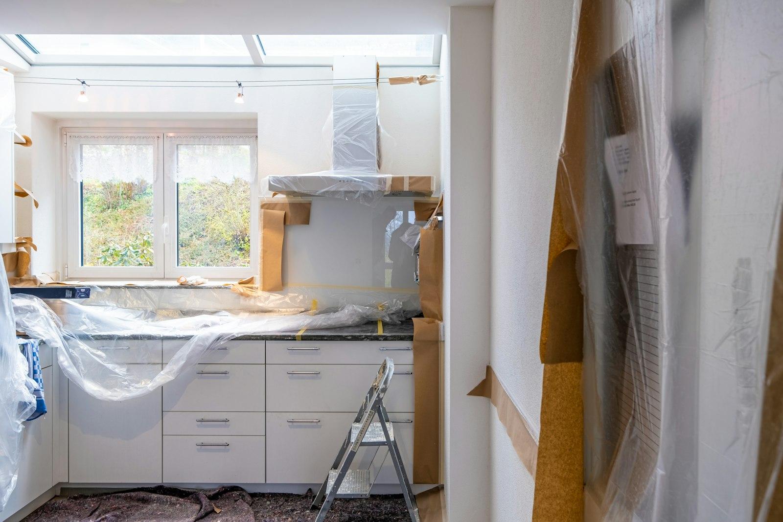 Kitchen interior masked and sheeted during renovation works